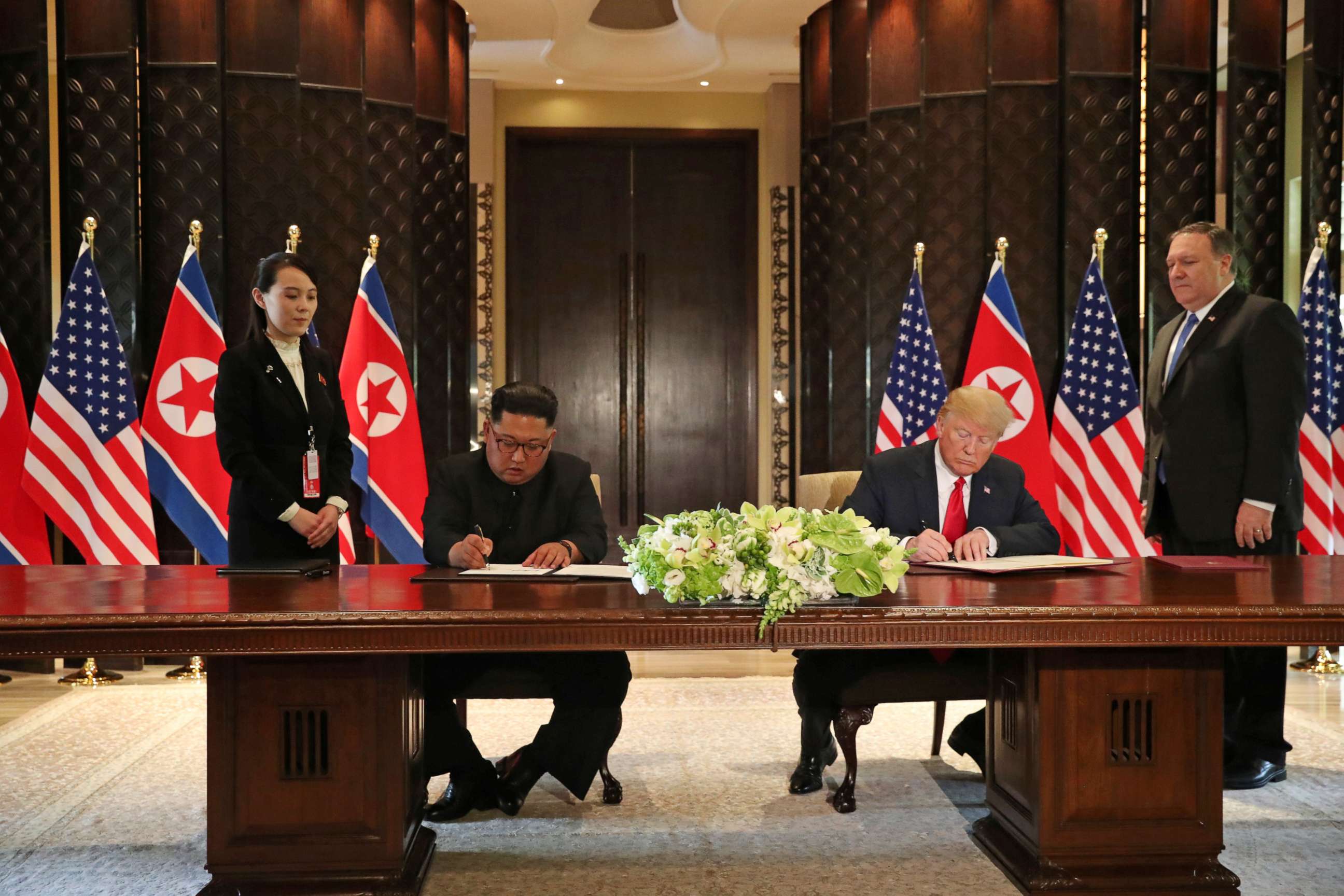 PHOTO: President Donald Trump and North Korea's leader Kim Jong Un sign documents that acknowledge the progress of the talks and pledge to keep momentum going, after their summit at the Capella Hotel on Sentosa island in Singapore June 12, 2018.