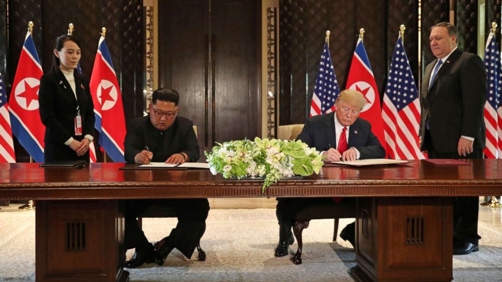 PHOTO: President Donald Trump and North Korea's leader Kim Jong Un sign documents that acknowledge the progress of the talks and pledge to keep momentum going, after their summit at the Capella Hotel on Sentosa island in Singapore June 12, 2018.