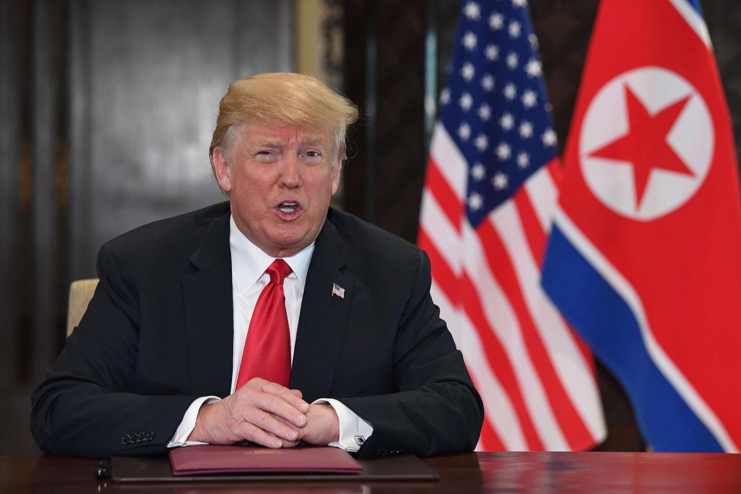 PHOTO: US President Donald Trump speaks at a signing ceremony with North Korea's leader Kim Jong Un during their historic summit, at the Capella Hotel on Sentosa island in Singapore on June 12, 2018.