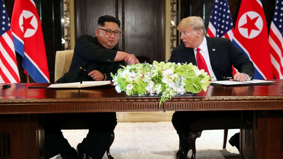 PHOTO: President Donald Trump shakes hands with North Korea's leader Kim Jong Un after signing documents after their summit at the Capella Hotel on Sentosa island in Singapore June 12, 2018.