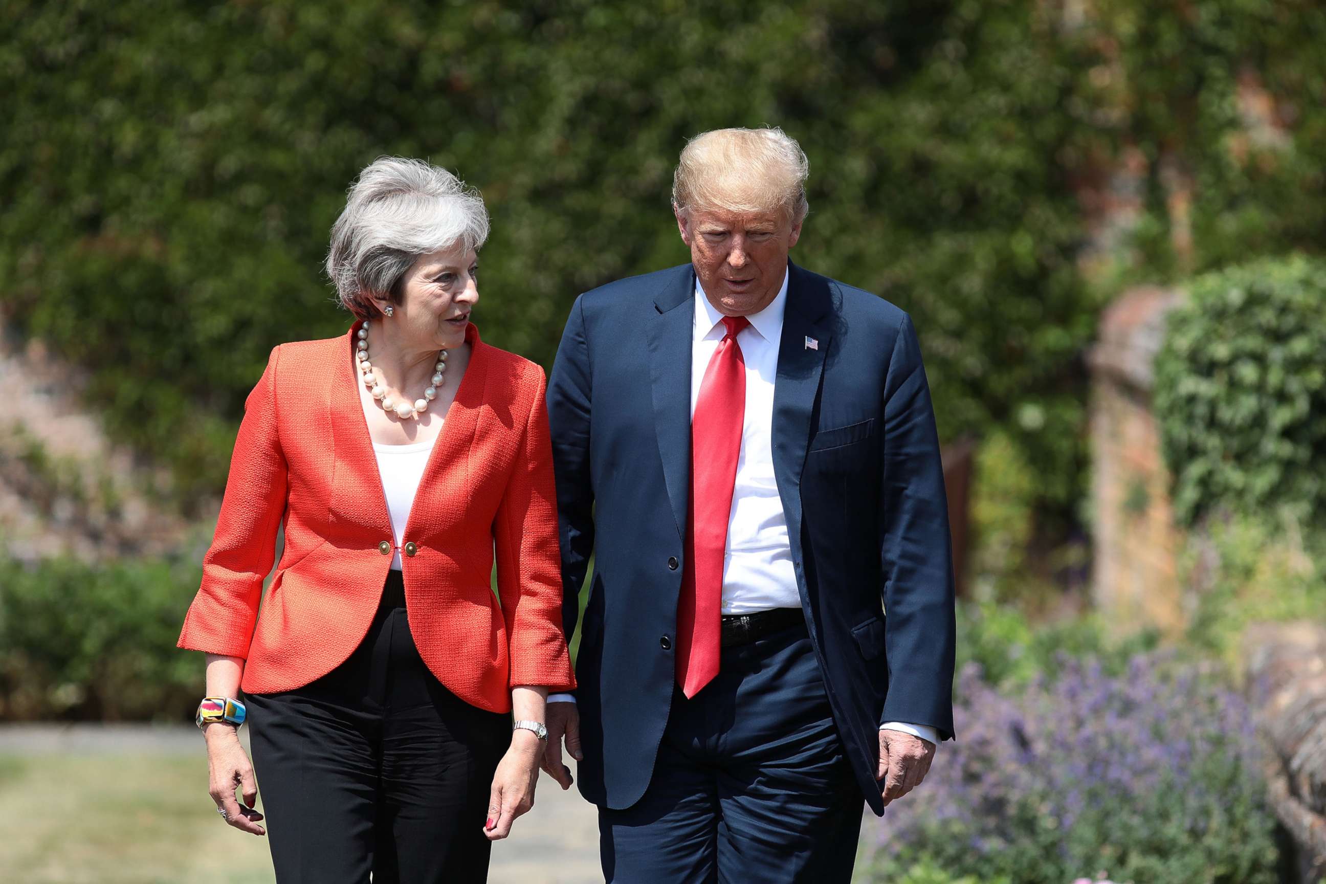 PHOTO: Prime Minister Theresa May walks with President Donald Trump at Chequers, July 13, 2018, in Aylesbury, England.