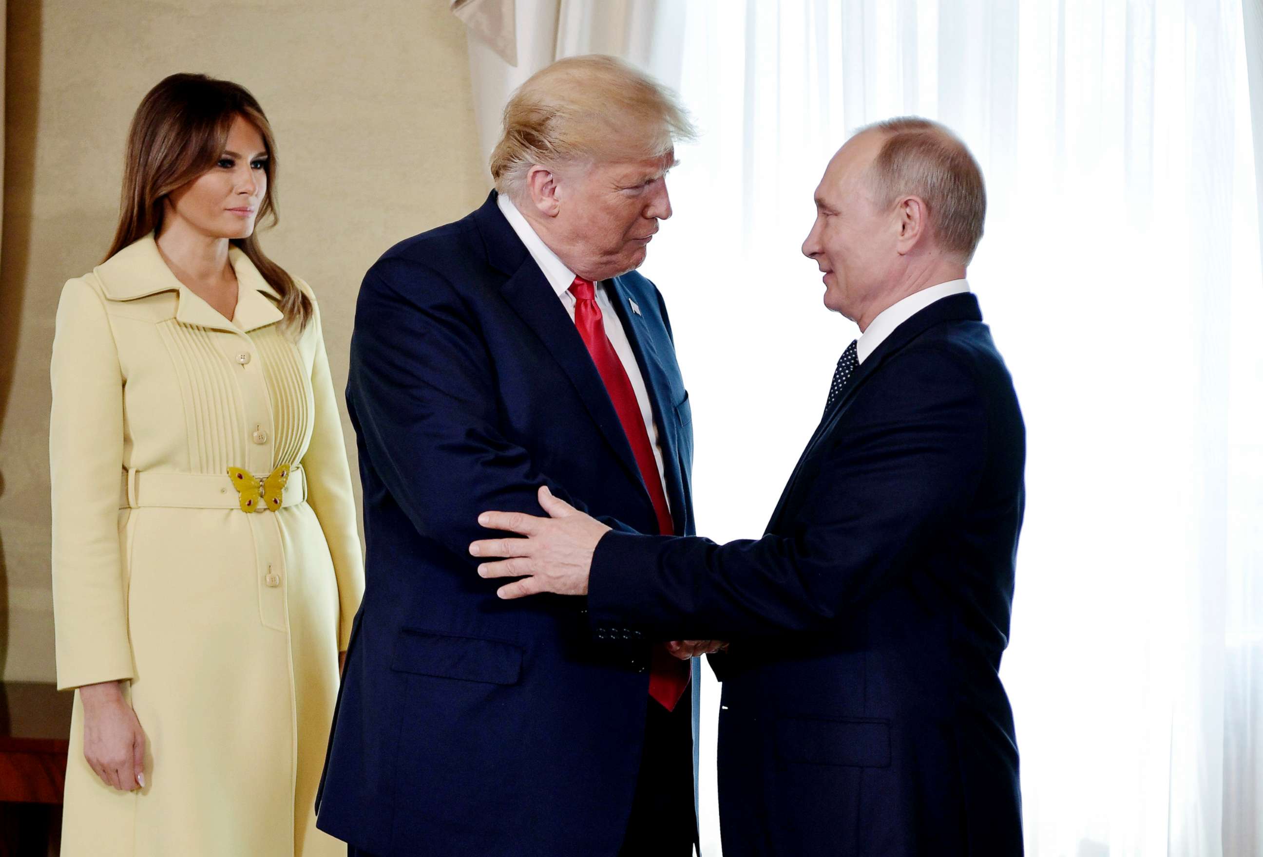 PHOTO: First lady Melania Trump, left, President Donald Trump and Russian President Vladimir Putin welcome each other at the Presidential Palace in Helsinki, Finland, July 16, 2018, prior to Trump's and Putin's one-on-one meeting in the Finnish capital.