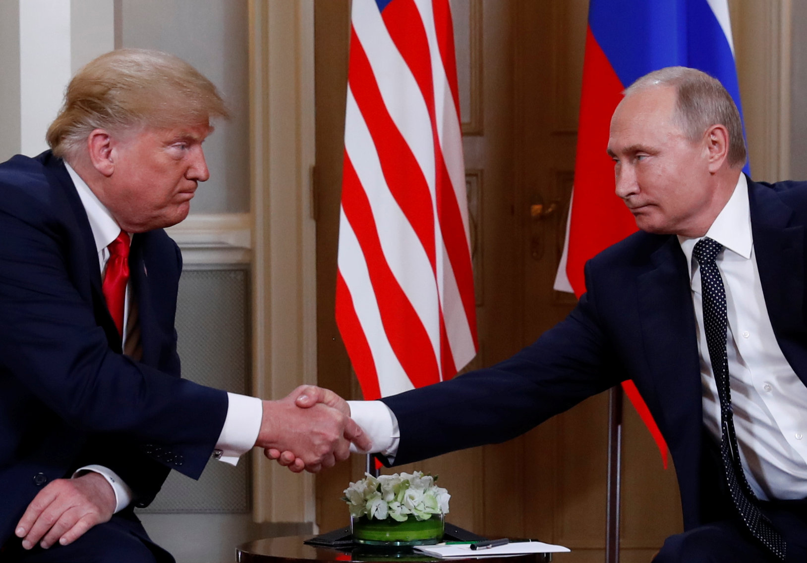 PHOTO: President Donald Trump and Russia's President Vladimir Putin shake hands as they meet in Helsinki, Finland, July 16, 2018.