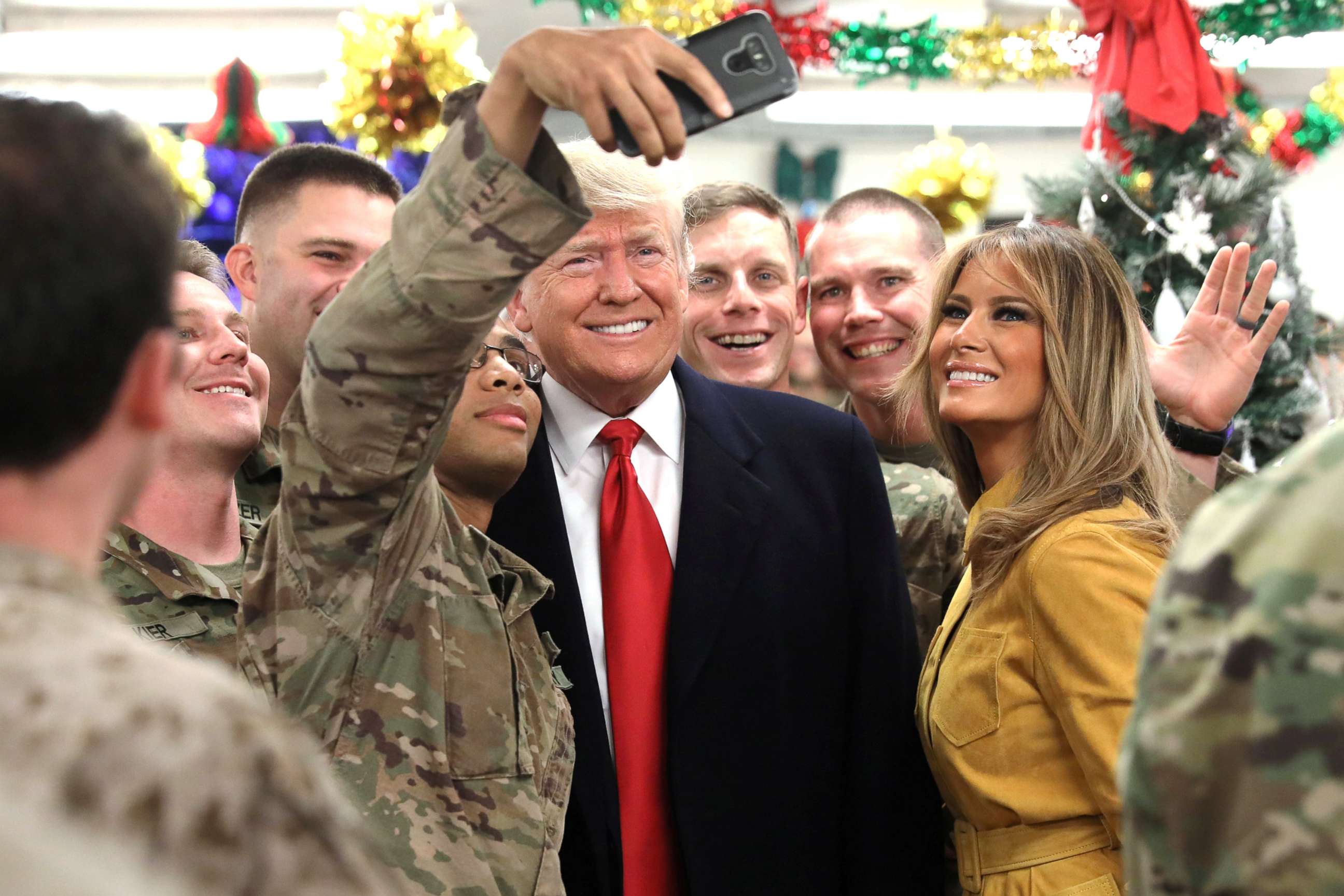 PHOTO: President Donald Trump and First Lady Melania Trump greet military personnel at the dining facility during an unannounced visit to Al Asad Air Base, Iraq, Dec. 26, 2018.