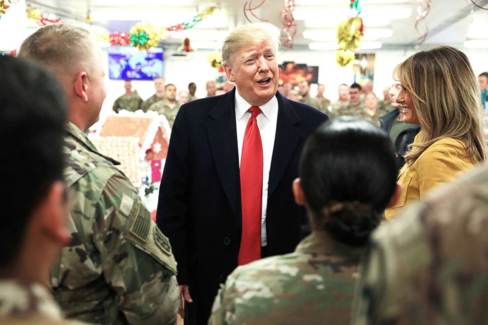 PHOTO: President Donald Trump and First Lady Melania Trump greet military personnel at the dining facility during an unannounced visit to Al Asad Air Base, Iraq Dec. 26, 2018.