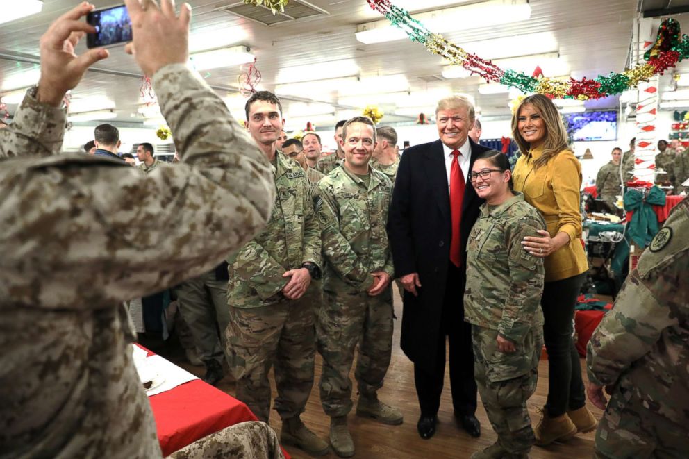 PHOTO: President Donald Trump and First Lady Melania Trump greet military personnel at the dining facility during an unannounced visit to Al Asad Air Base, Iraq Dec. 26, 2018.