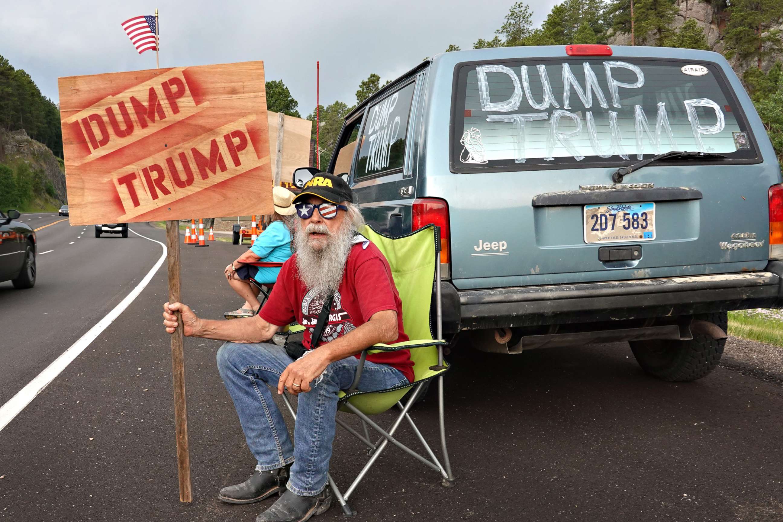 PHOTO: Mike Harris, a retired over-the-road truck driver and registered Republican, shares his views about President Donald Trump with motorists heading toward Mount Rushmore National Monument in Keystone, South Dakota, on July 02, 2020.