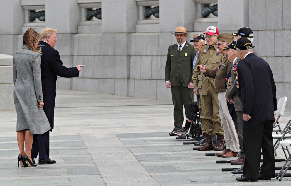 PHOTO: President Donald Trump points as he and first lady Melania Trump greet a group of World War II veterans during a Victory in Europe Day 75th anniversary ceremony at the World War II Memorial in Washington, May 8, 2020.