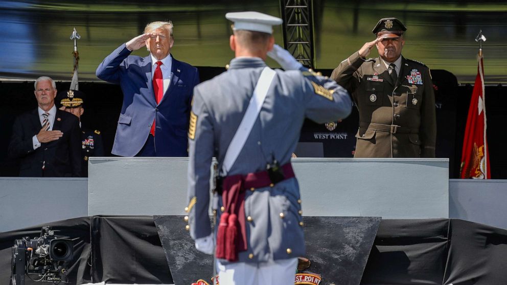 PHOTO: President Donald Trump, left, and United States Military Academy superintendent Darryl A. Williams, right, salute alongside graduating cadets as the national anthem is played during commencement ceremonies, June 13, 2020, in West Point, N.Y.