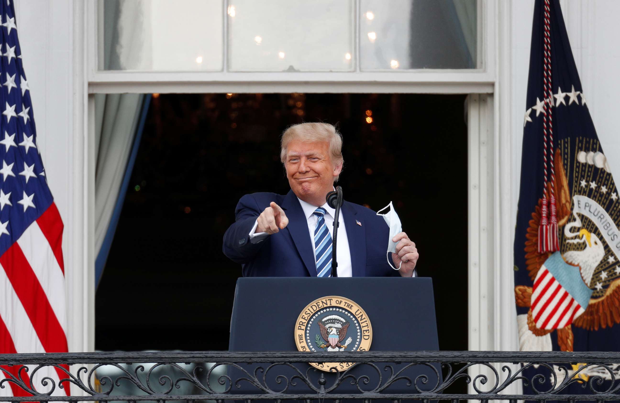 PHOTO: President Donald Trump gestures as he stands on a White House balcony speaking to supporters gathered on the South Lawn for a campaign rally that the White House is calling a "peaceful protest" in Washington, Oct. 10, 2020.