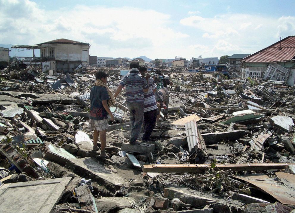 PHOTO: Residents in Banda Aceh, Indonesia, carry the body of a dead relative the day after a devastating earthquake flattened the area, Dec. 27, 2004. 