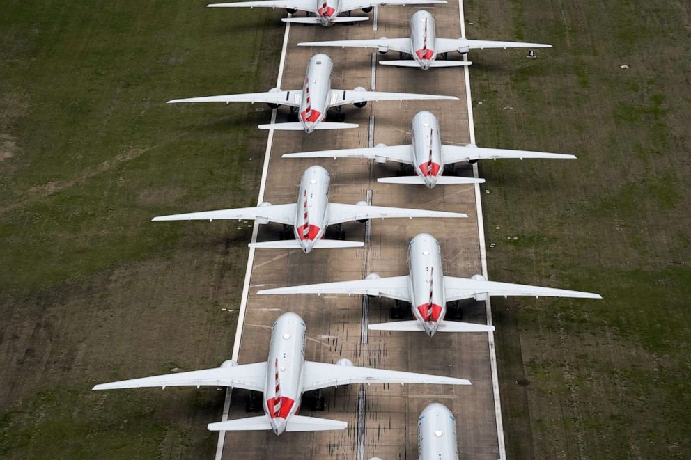 PHOTO: American Airlines passenger planes sit on a runway at Tulsa International Airport where they are parked due to flight reductions because of the coronavirus pandemic, March 23, 2020, in Tulsa, Okla.