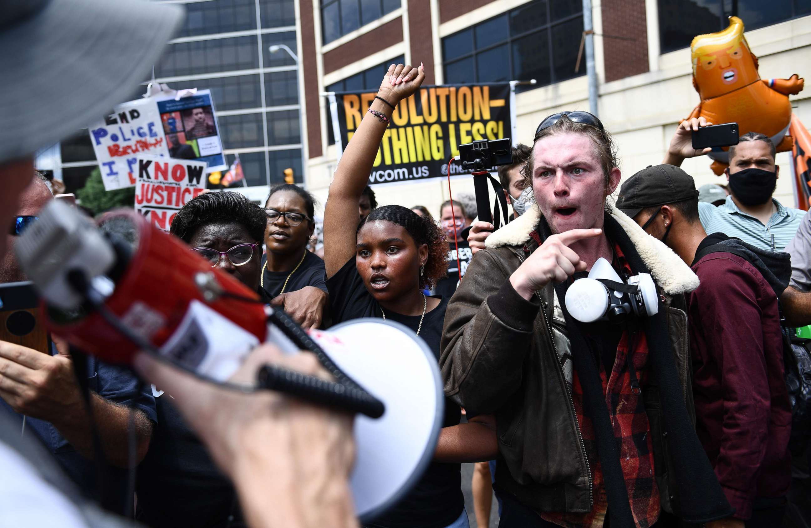 PHOTO: Black Lives Matter protesters demonstrate near the entrance to a campaign rally to be held by President Donald Trump later in the evening at the BOK Center, June 20, 2020, in Tulsa, Okla.