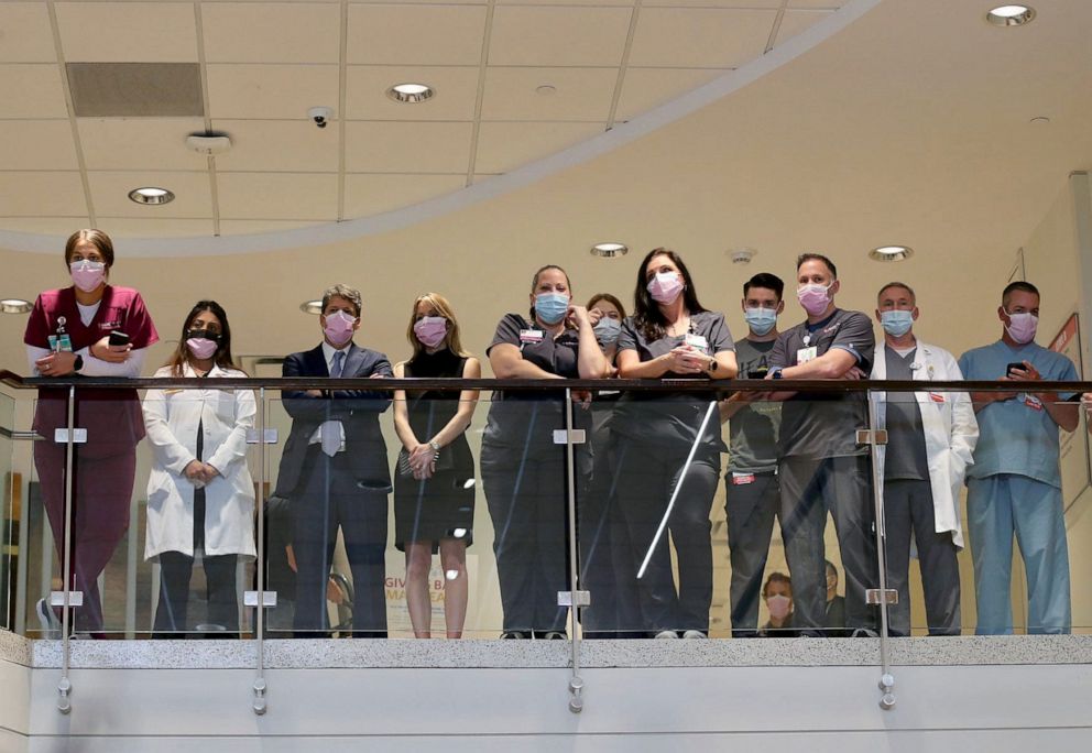 PHOTO: Medical personnel look on as Tulsa Police Chief Wendell Franklin speaks during during a press conference, June 2, 2022, in Tulsa, Okla, after a mass shooting that killed multiple people at Saint Francis Hospital on Wednesday.