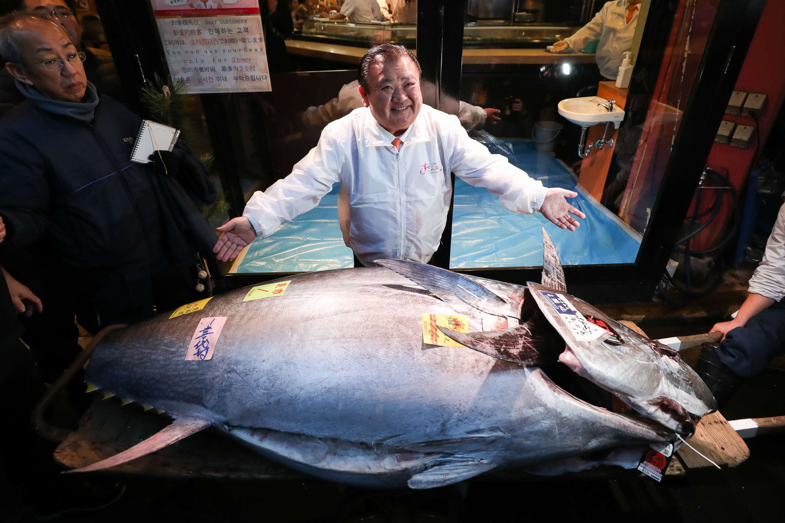 PHOTO: Kiyoshi Kimura, president of Kiyomura Co. center, poses with a tuna in front of one of the company's Sushi Zanmai restaurants after the year's first auction at Toyosu Market, Jan. 5, 2020, in Tokyo.