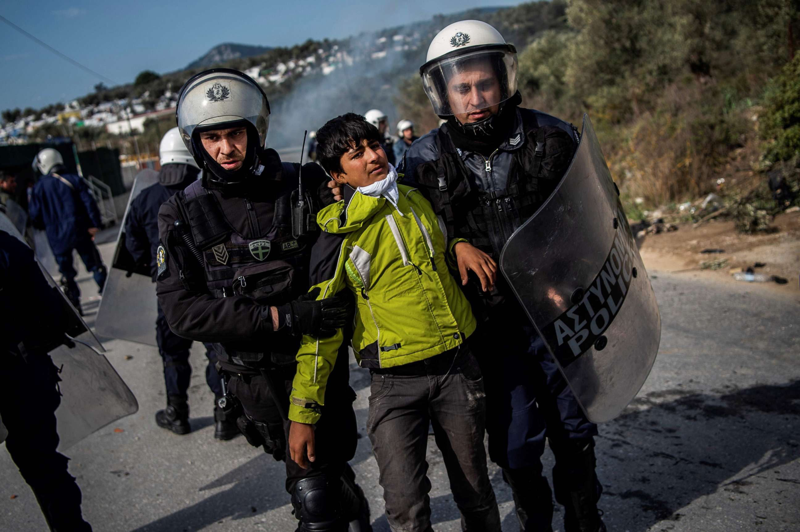 PHOTO: Riot police detain a migrant during clashes near the Moria camp for refugees and migrants, on the island of Lesbos, March 2, 2020. 