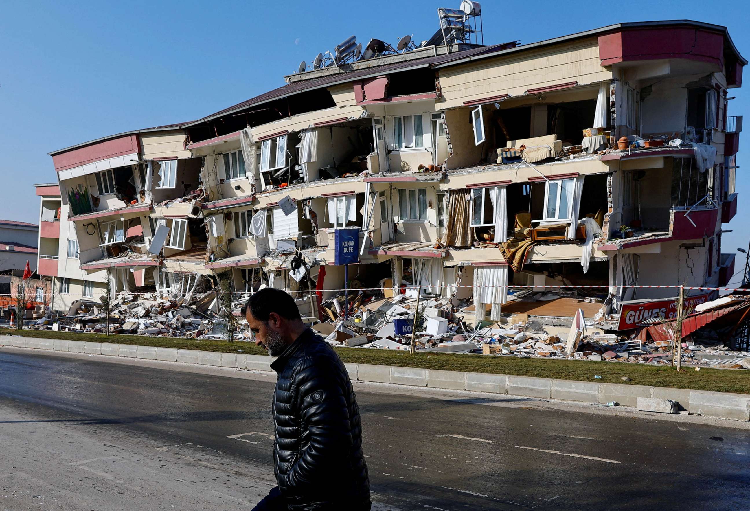 PHOTO: A man walks past a damaged building in the aftermath of a deadly earthquake in Kahramanmaras, Turkey, Feb. 13, 2023.