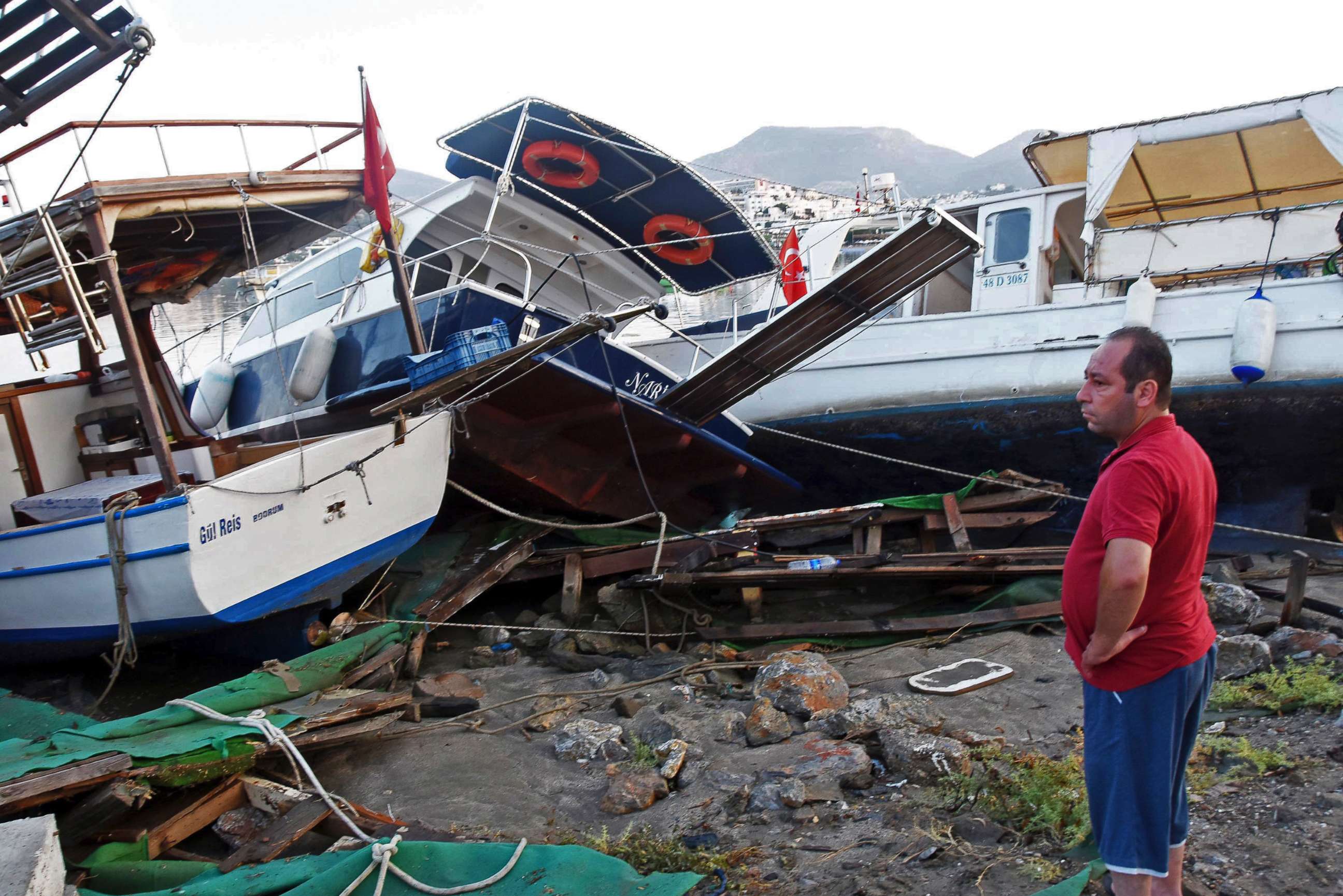 PHOTO: A man looks at boats that crashed on top of each other in the harbor as a result of the overnight earthquake in Bodrum, Turkey, July 21, 2017.
