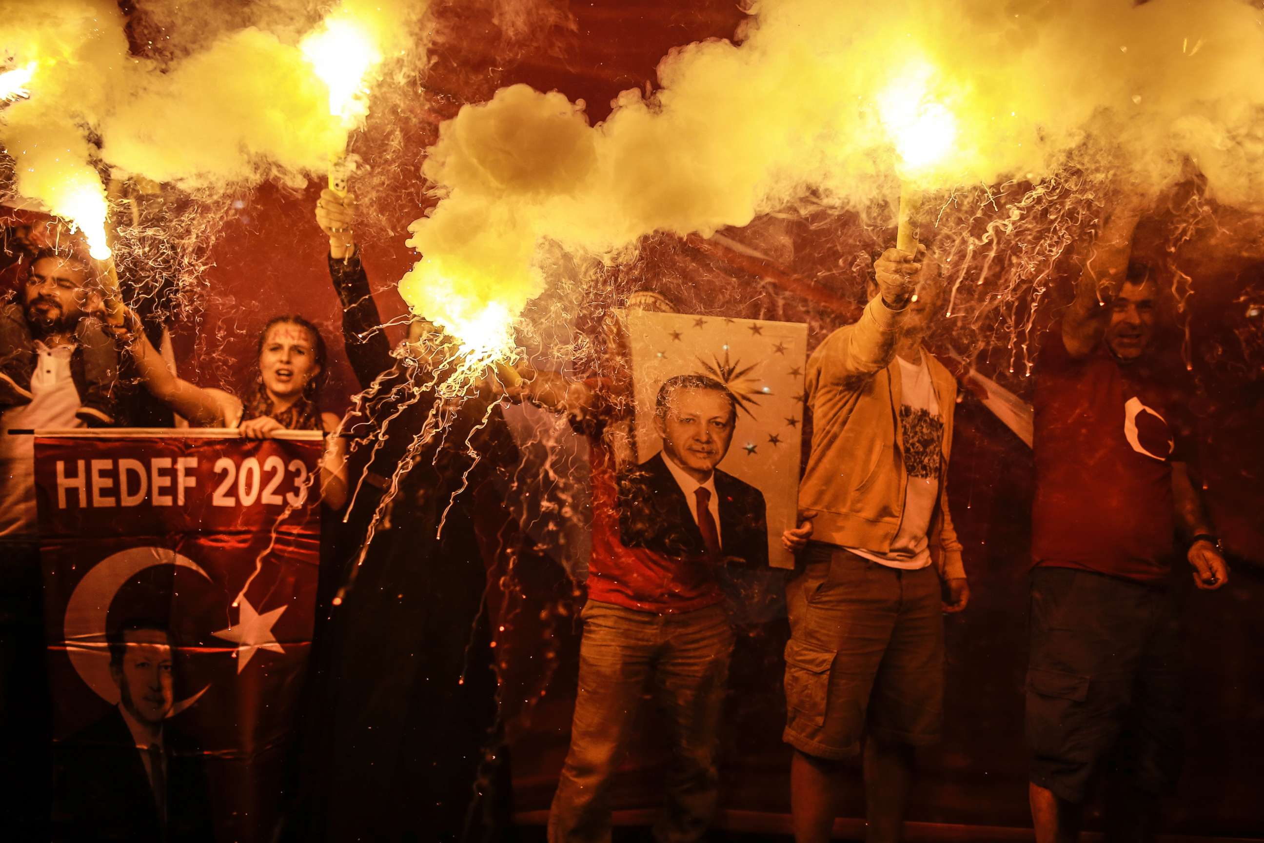 PHOTO: Supporters of Turkey's President and ruling Justice and Development Party, or AKP, leader Recep Tayyip Erdogan light flares during celebrations outside the party headquarters in Istanbul, June 24, 2018.