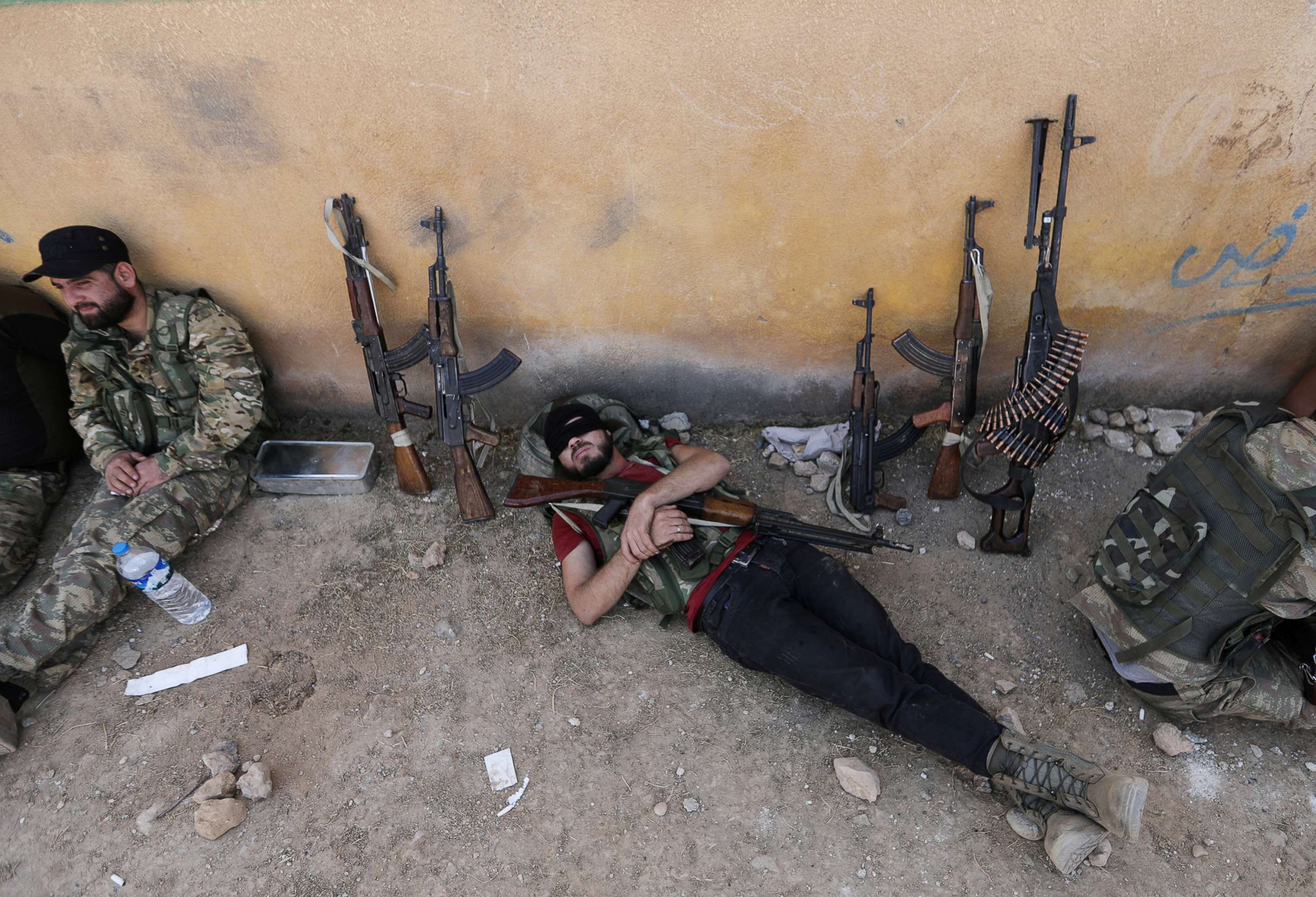 PHOTO: A Turkey-backed Syrian rebel fighter takes a rest near the border town of Tal Abyad, Syria, Oct. 22, 2019.