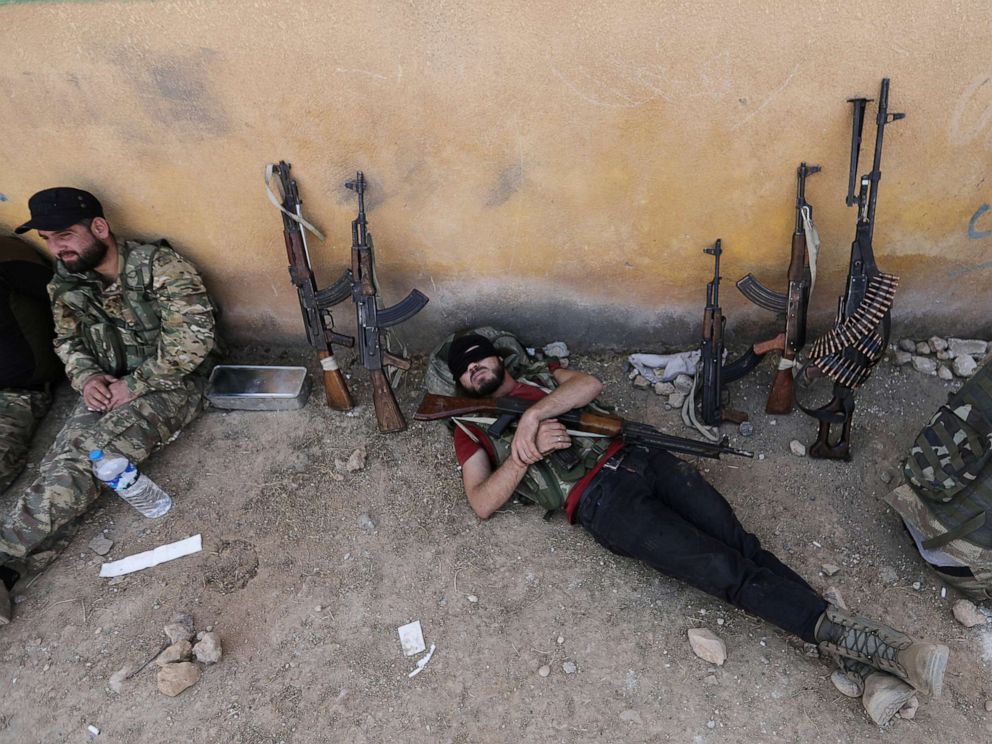 PHOTO: A Turkey-backed Syrian rebel fighter takes a rest near the border town of Tal Abyad, Syria, Oct. 22, 2019.