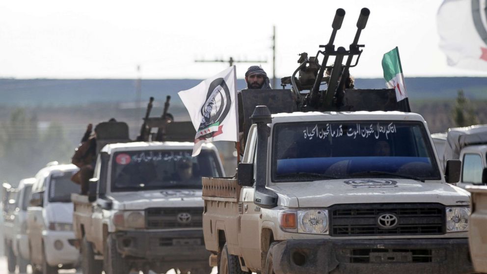 A Turkish-backed Syrian rebel rides on a truck with a mounted weapon in the Manbij countryside, Syria, Dec. 28, 2018.