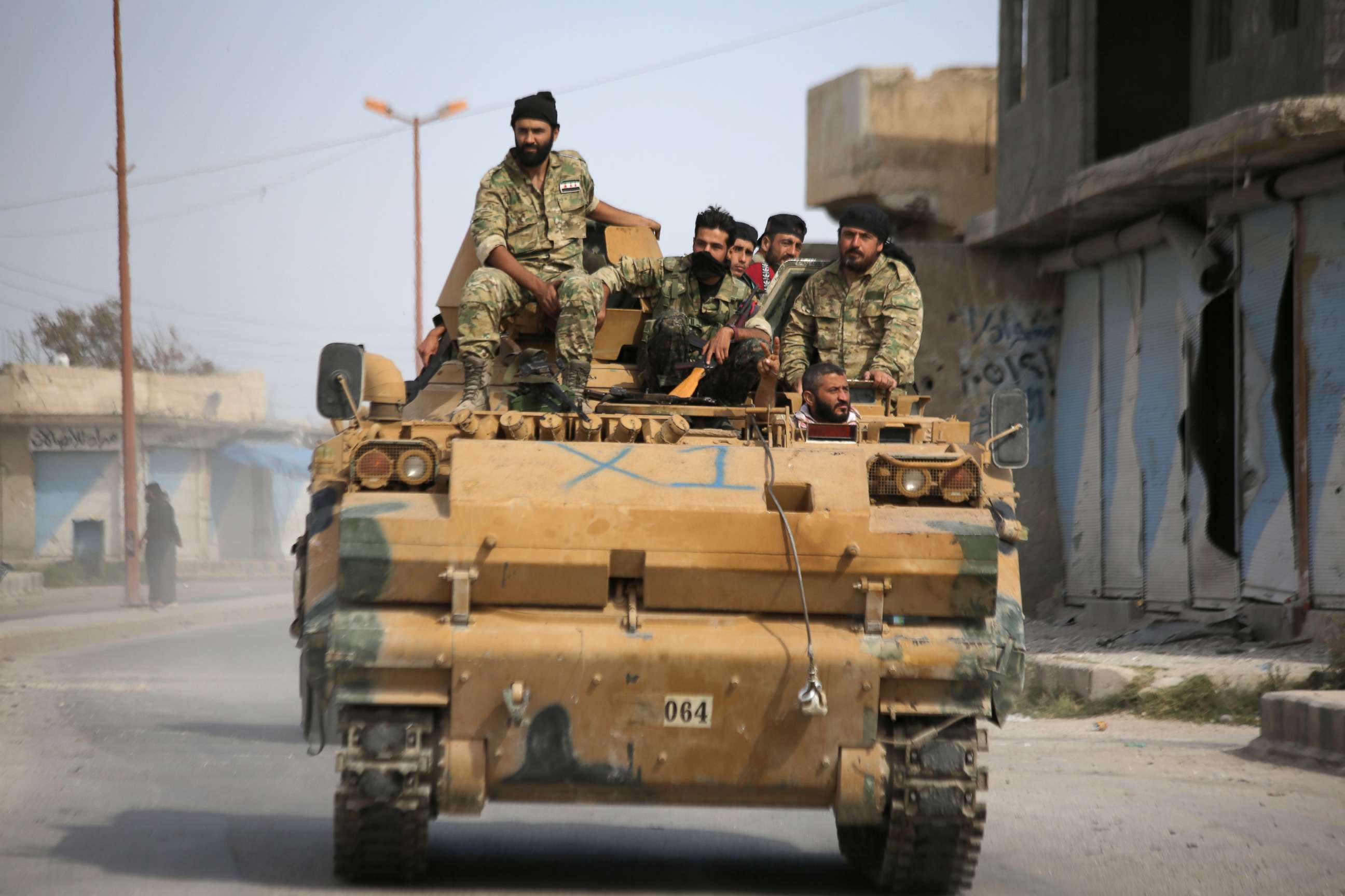 PHOTO: Turkish-backed Syrian fighters are pictured in the town of Ayn al-Arus, south of the border town of Tal Abyad, on Oct. 14, 2019.