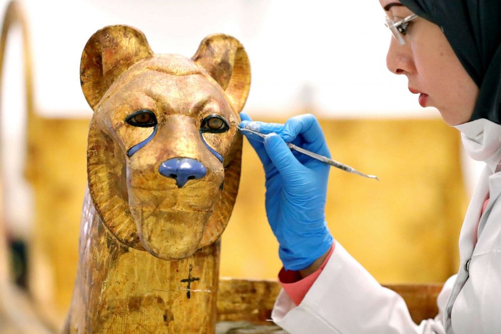 PHOTO: An Egyptian archaeologist restores the throne of the throne of King Tutankhamun at the conservation center in the Grand Egyptian Museum, Aug. 4, 2019. 