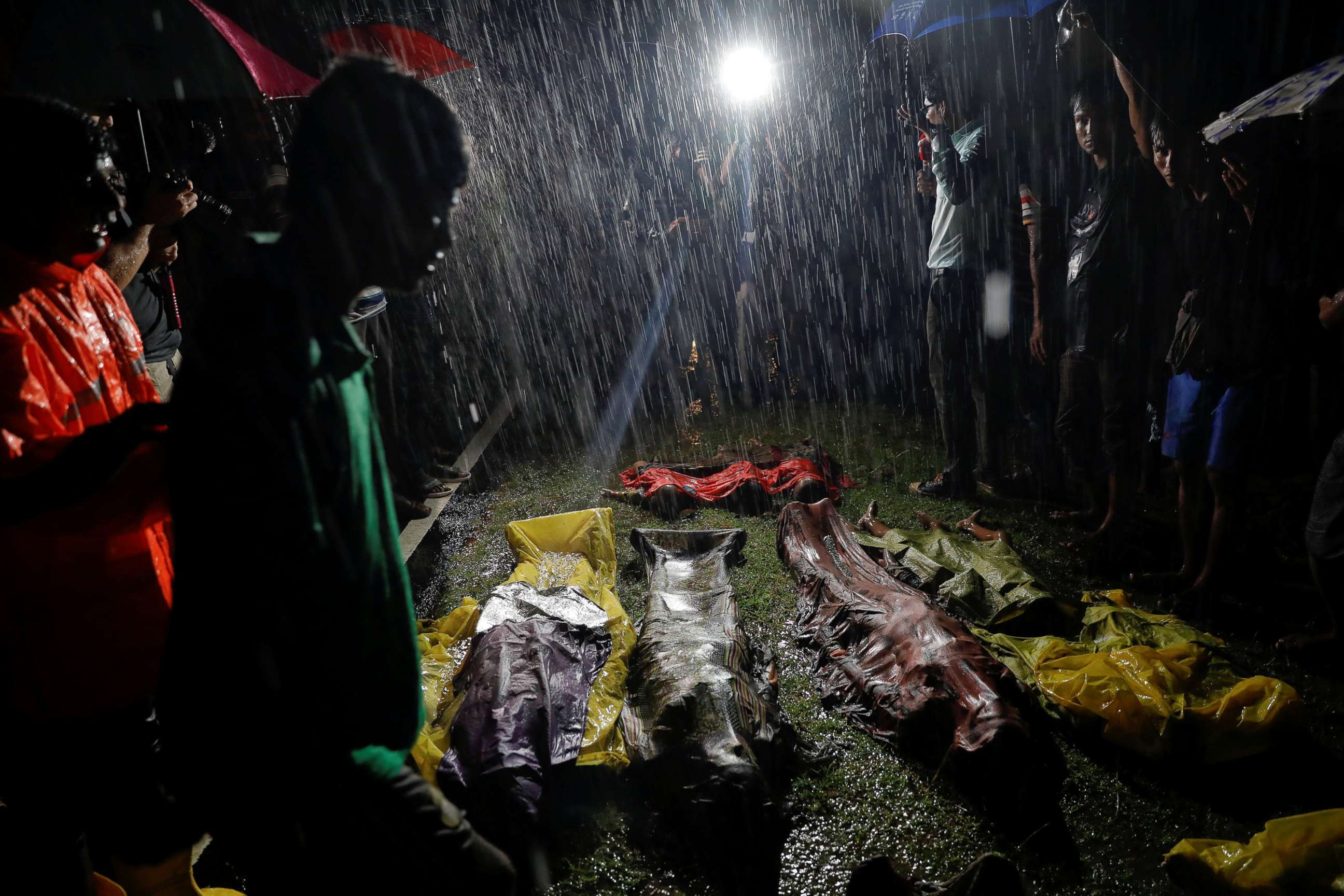 PHOTO: People gather in the rain around bodies of Rohingya refugees after their boat capsized off the Inani beach near Cox's Bazar, Bangladesh, Sept. 28, 2017. 