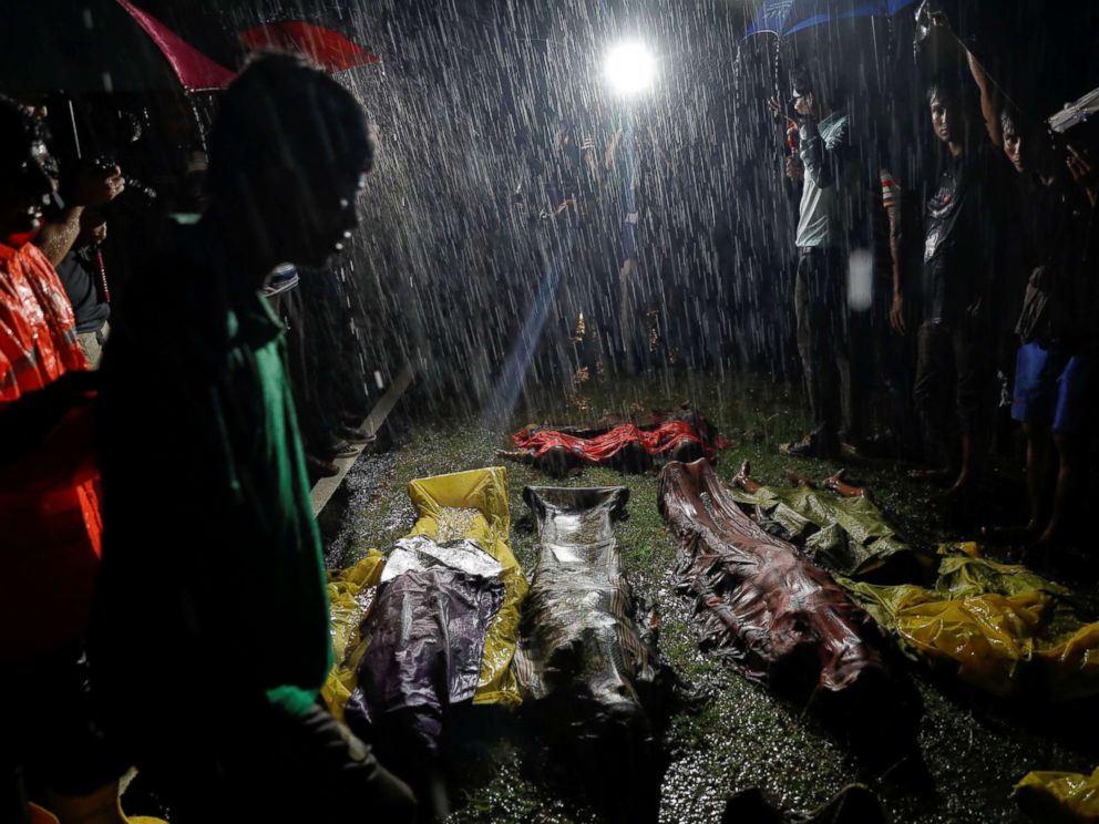 PHOTO: People gather in the rain around bodies of Rohingya refugees after their boat capsized off the Inani beach near Coxs Bazar, Bangladesh, Sept. 28, 2017.
