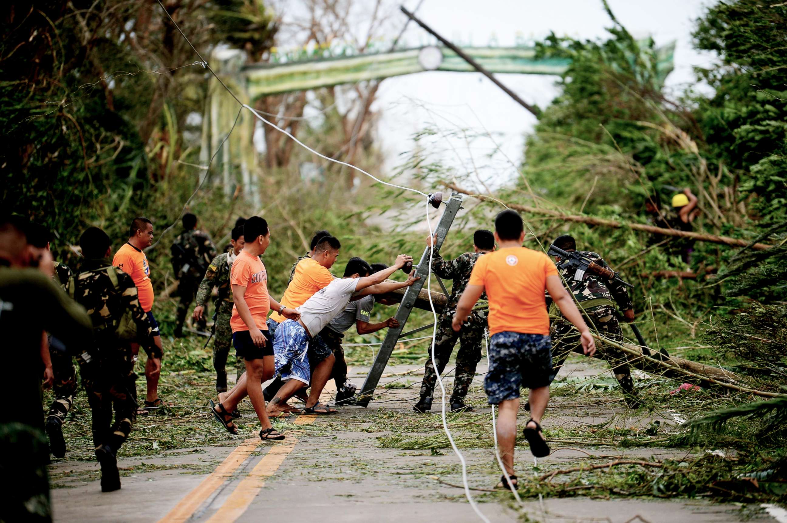 PHOTO: Rescue workers clear a road of debris and toppled electric posts caused by strong winds due to super Typhoon Mangkhut as they try to reach Baggao town, north of Manila, Philippines, Sept. 15, 2018.