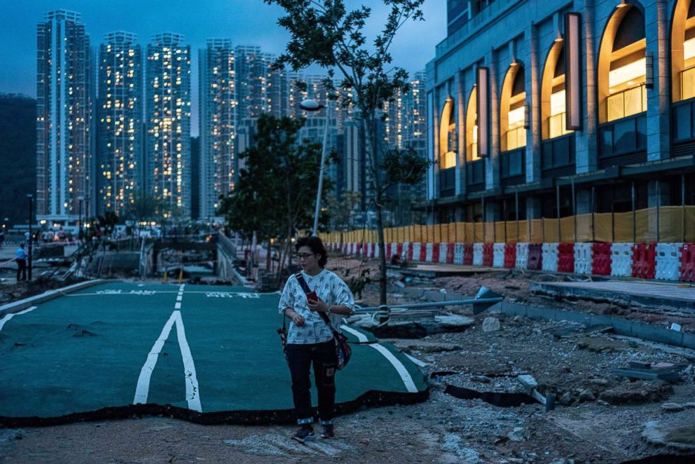 PHOTO: A woman walks along a ruined cycling path destroyed by Typhoon Mangkhut in Hong Kong, Sept. 17, 2018.