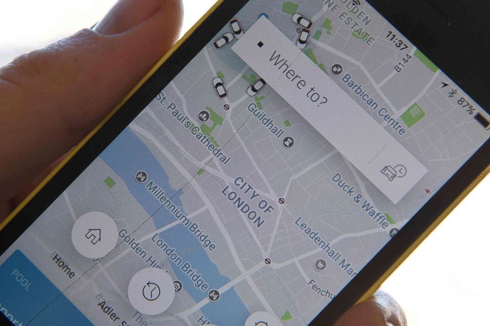 PHOTO: A man poses holding a smartphone showing the App for ride-sharing cab service Uber in London, Sept. 22, 2017.