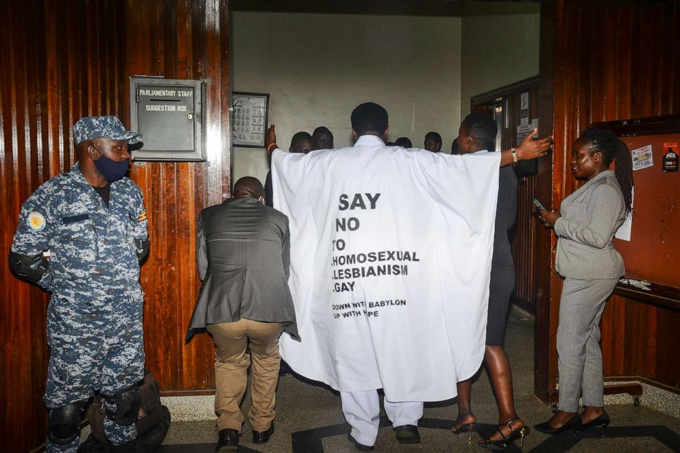 PHOTO: In this March 21, 2023, file photo, Ugandan MP John Musila wears clothes with an anti-LGBTQ message as he enters the Parliament to vote on a harsh new anti-gay bill.