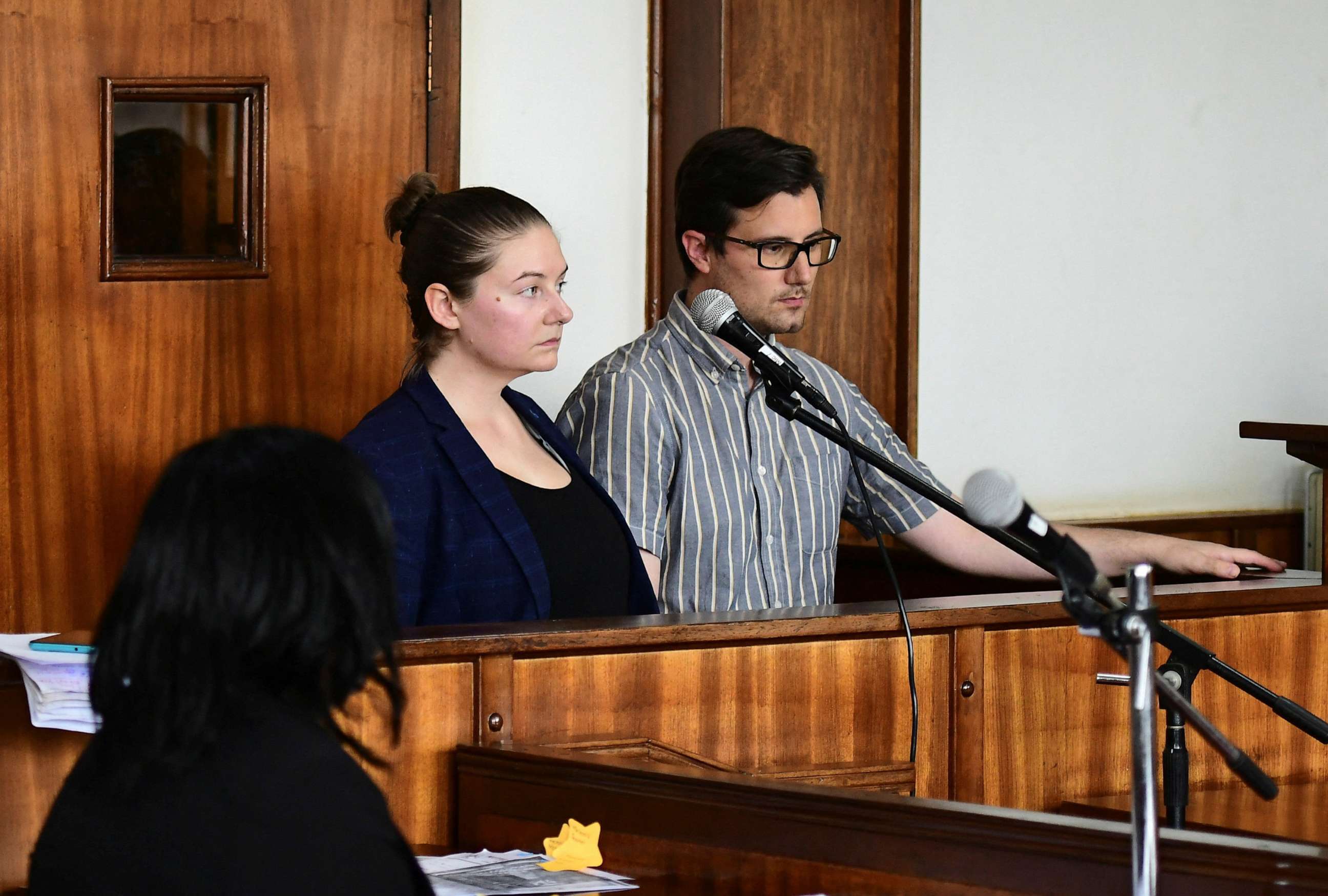 PHOTO: American couple Nicholas Spencer and Mackenzie Leigh Mathias Spencer, both 32, stand in the dock at Buganda road court, where they were charged with torturing a 10-year-old, in Kampala, Uganda, on Dec. 14, 2022.