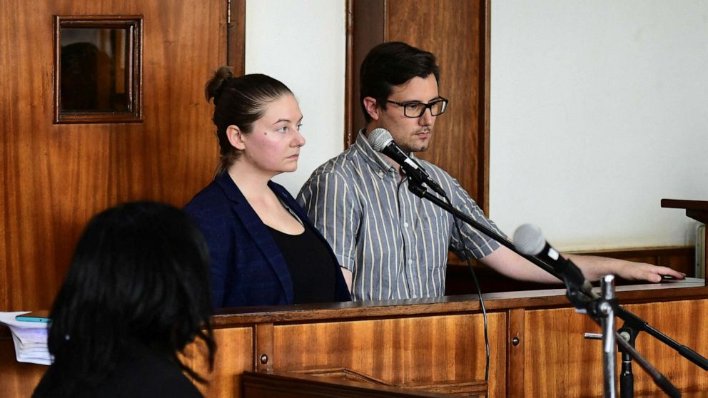 Photo: American couple Nicholas Spencer and Mackenzie Lee Matthias Spencer stand on the docks of the Buganda Road Court charged with torturing a 10-year-old boy December 14, 2022 in Kampala, Uganda. 32 years old).