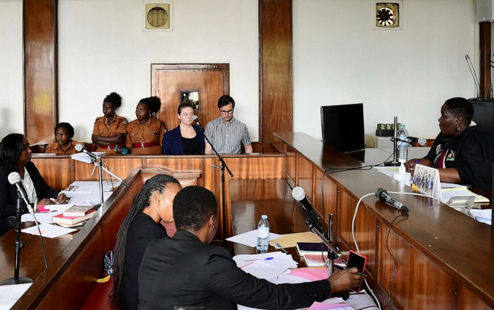 Photo: American couple Nicholas Spencer and Mackenzie Lee Matthias Spencer stand on the docks of the Buganda Road Court charged with torturing a 10-year-old boy December 14, 2022 in Kampala, Uganda. 32 years old).