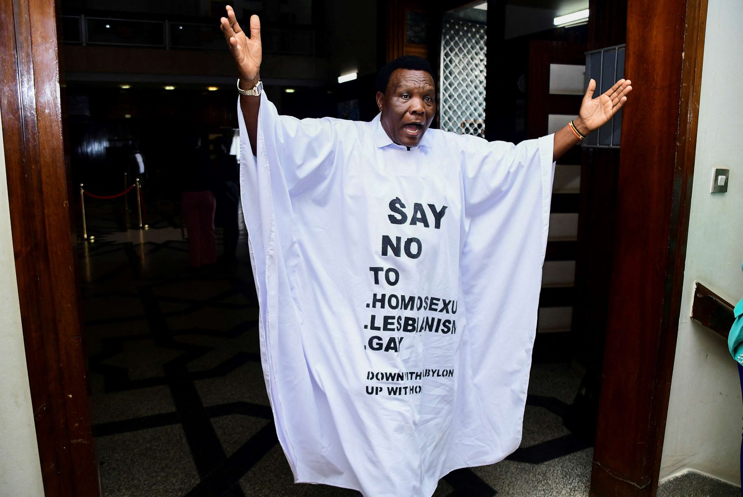 PHOTO: Member of Parliament John Musira dressed in an anti gay gown gestures as he leaves the chambers during the debate of Uganda's Anti-Homosexuality bill, in Kampala, Uganda, March 21, 2023.