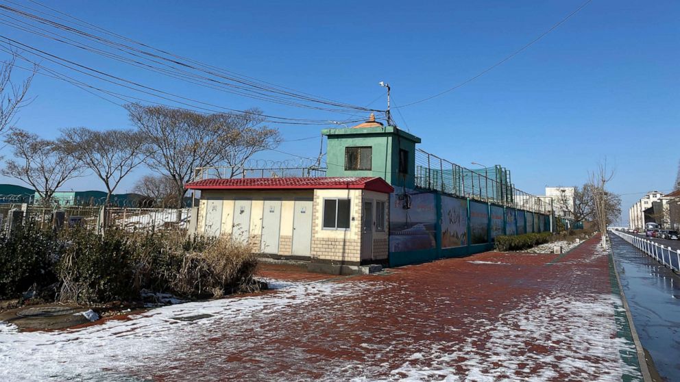 PHOTO: In this Jan. 8, 2020, file photo, the fences along the side of the Qingdao Taekwang Shoes Co. factory, the side where the Uighur workers enter and exit, and live in dorms, looks almost like a prison, in Laixi, China.