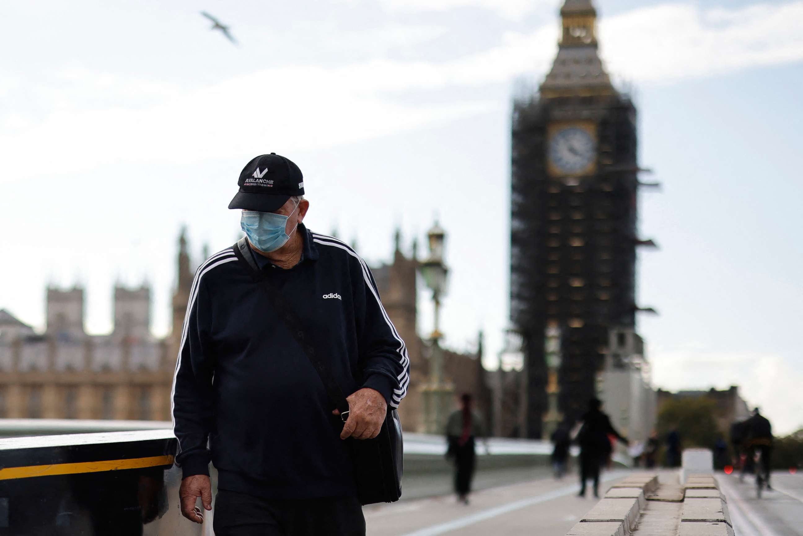 PHOTO: A pedestrian wears a facemask as he walks along Westminster Bridge in London,  Oct. 20, 2021. 