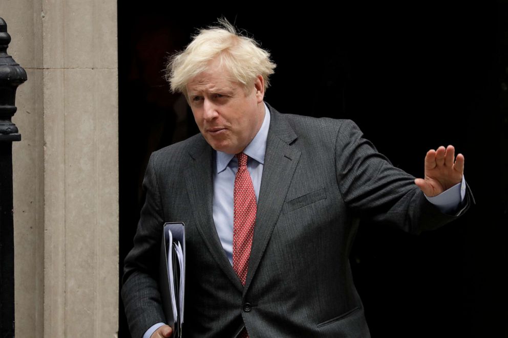 PHOTO: British Prime Minister Boris Johnson waves at the media as he leaves his official residence and office at 10 Downing Street in London to go to the Houses of Parliament to make a statement on new coronavirus-related restrictions on Sept. 22, 2020.