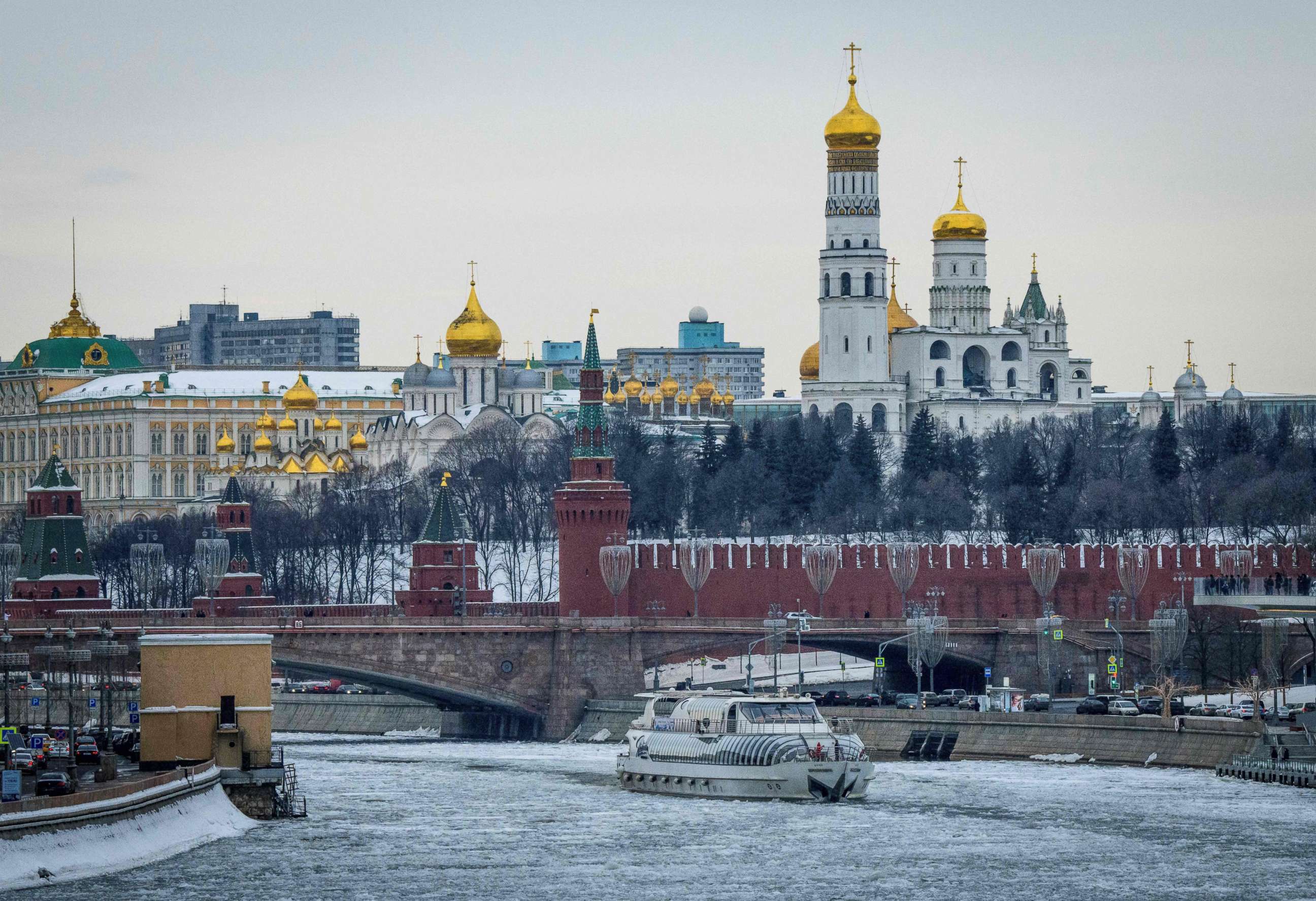 PHOTO: A tourist boat breaks through the frozen Moskva river outside the Kremlin in Moscow on March 13, 2018.
