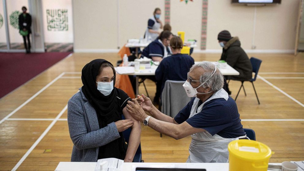 PHOTO: A health worker administers a dose of the AstraZeneca/Oxford Covid-19 vaccine to a patient at a vaccination centre set up at the Karimia Institute Islamic centre and Mosque in Nottingham, England, April 6, 2021.