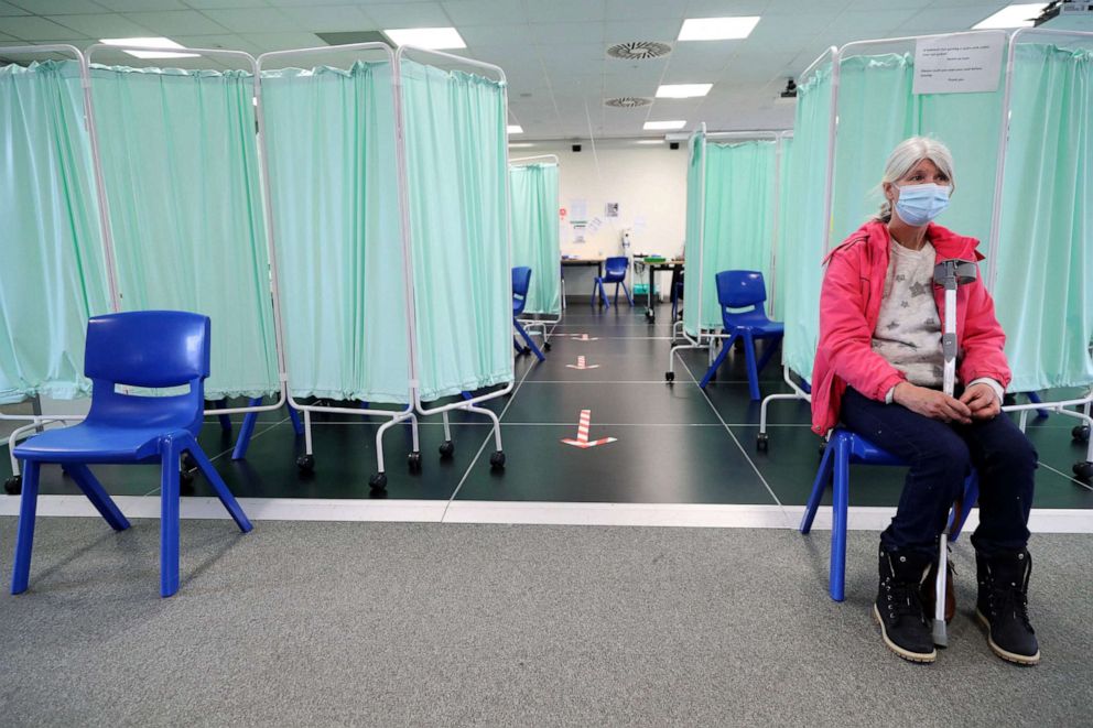 PHOTO: A member of the public sits in the waiting area after receiving a doser of the Moderna Covid-19 vaccine at a vaccination centre at Ffwrnes Theatre in Llanelli, South Wales, April 9, 2021.