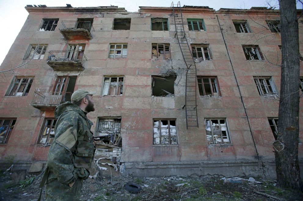 PHOTO:A Ukrainian serviceman walks past a building destroyed as a result of shelling by Russia-backed separatists in the small town of Zolote, April 20, 2019, on the eve of the second round of Presidential election in Ukraine. 