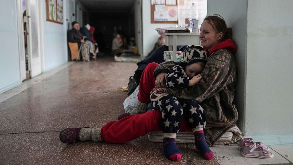 PHOTO: Anastasia Erashova cries as she hugs the one remaining living child of her three children in a corridor of a hospital in Mariupol, eastern Ukraine, March 11, 2022. Anastasia's other two children were killed during the shelling of Mariupol.