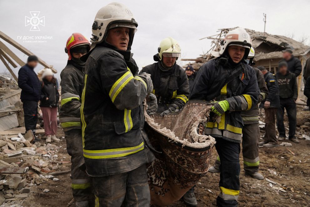 PHOTO: Rescuers carry a body of a killed person a site of residential buildings destroyed by a Russian missile strike, amid Russia's attack on Ukraine, in Lviv region, Ukraine, March 9, 2023.
