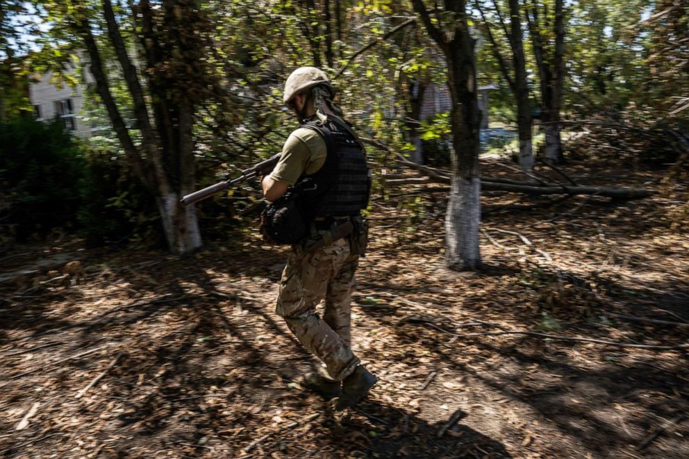 PHOTO: A soldier with the call sign Bury walks in one of the villages near the Kherson frontline in Mykolaiv region, Ukraine, Aug. 8, 2022.