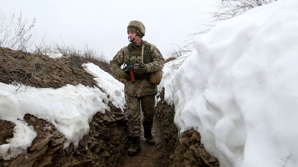 PHOTO: A Ukrainian Military Forces serviceman walks on a trench on the front line with Russia-backed separatists near Luganske village, in Donetsk region on Jan. 11, 2022.