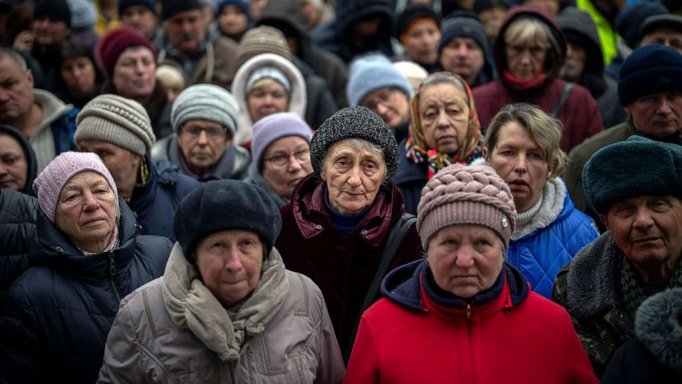PHOTO: Ukrainians wait at a food distribution event organised by the Red Cross in Bucha, on the outskirts of Kyiv, on Monday, April 18, 2022.